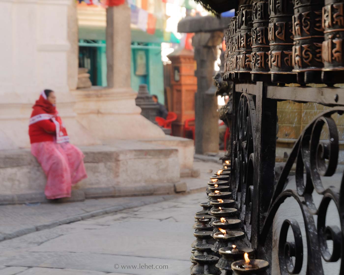 Candles, Prayer Wheels, Woman in Red and Pink